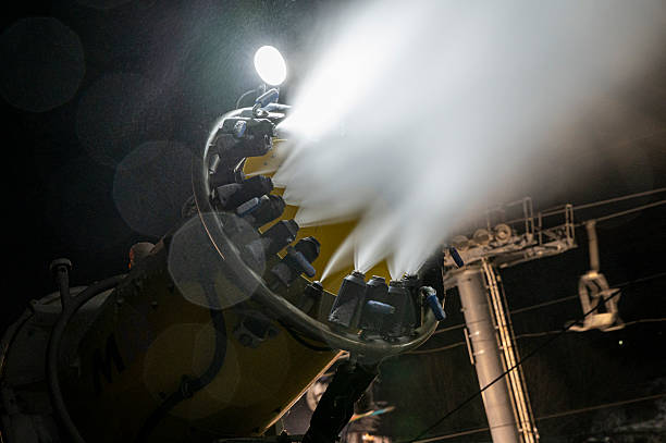 Snow Gun Making Snow At Night On The Ski Slope. Snow Making System At Work.