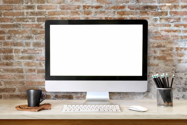 Mock up  Workspace Desktop Computer : Creative designer desktop with blank white Desktop computer, pencils and stationery items. Blank screen for graphics display montage.