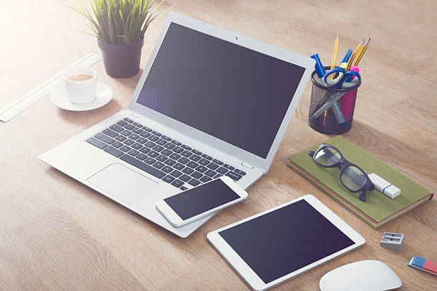 Responsive design mockup for online webdesign. On table top with different office items